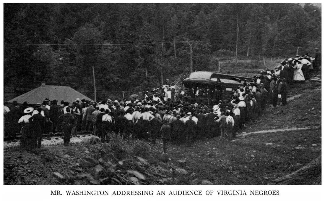 Picture of Booker T. Washington speaking to a crowd from the back of a train.