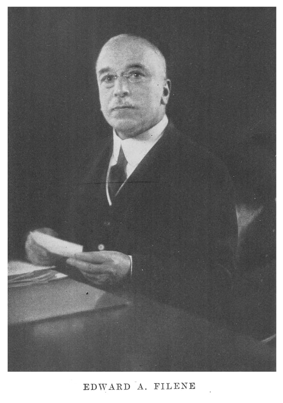 A picture of Edward A. Filene working at his desk.