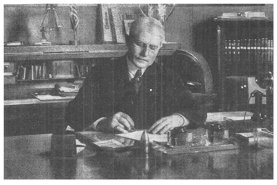 George Verity at his desk.