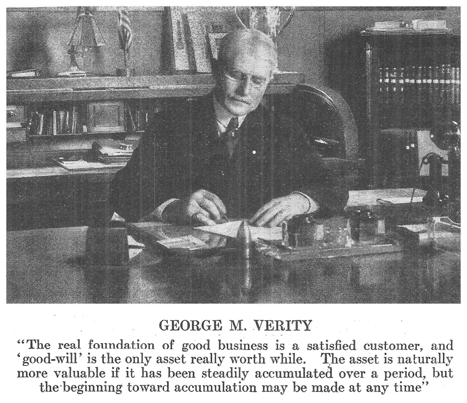 Picture of George M. Verity working at his desk.
