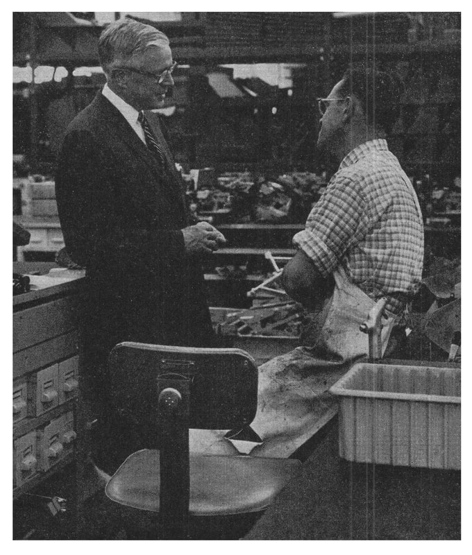 Picture of Thomas J. Watson Jr. talking with an employee in the lab: Management by Wandering Around (MBWA).