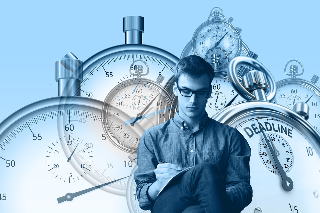 Picture of man with timepieces in background.