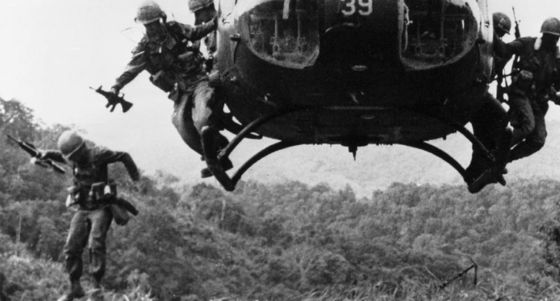 Image of men jumping from helicopter in Vietnam.