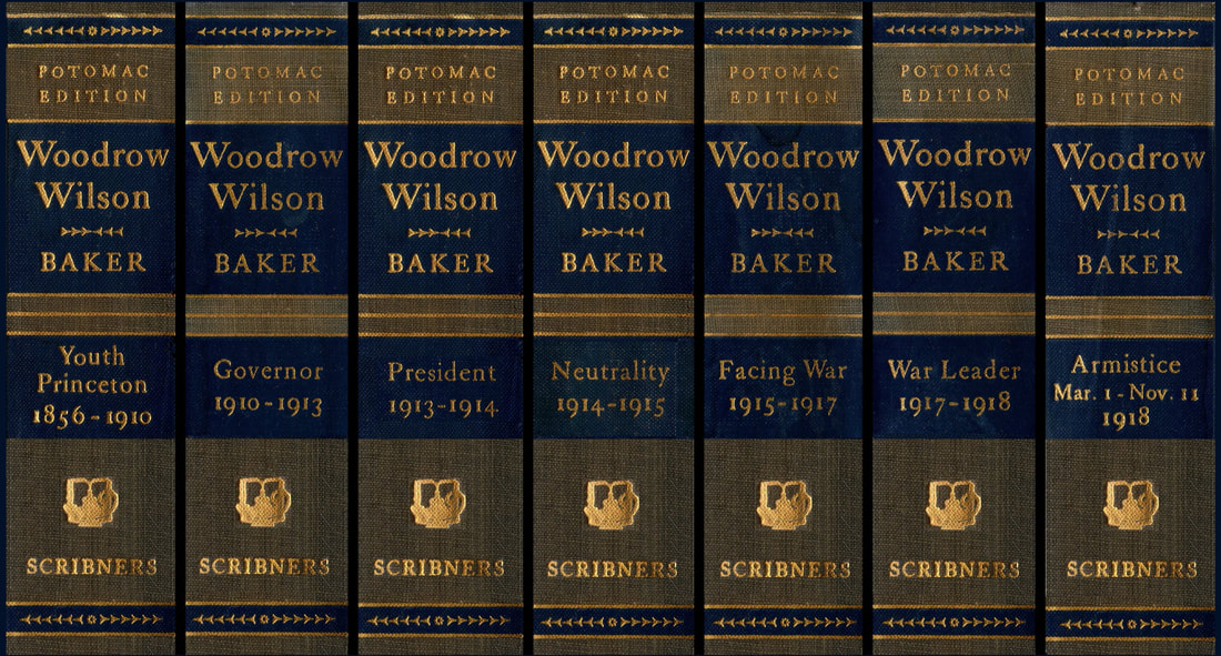 Picture of the collected spines of the seven-volume set of books in 